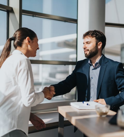 Mann schüttelt Frau die Hand